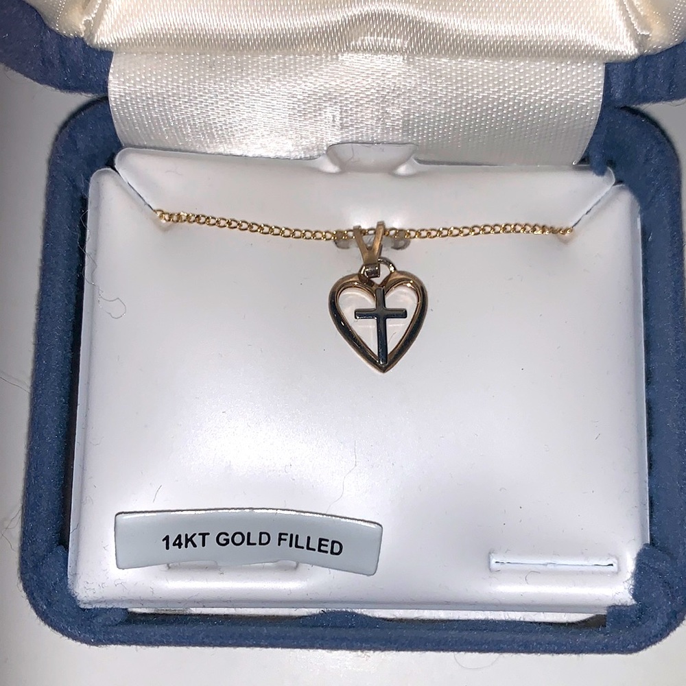 Small silver cross inside gold heart